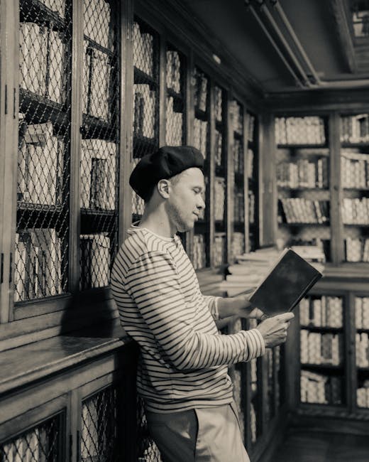 A man in a classic library reads a book. Captured in sepia within a historic Buenos Aires library.